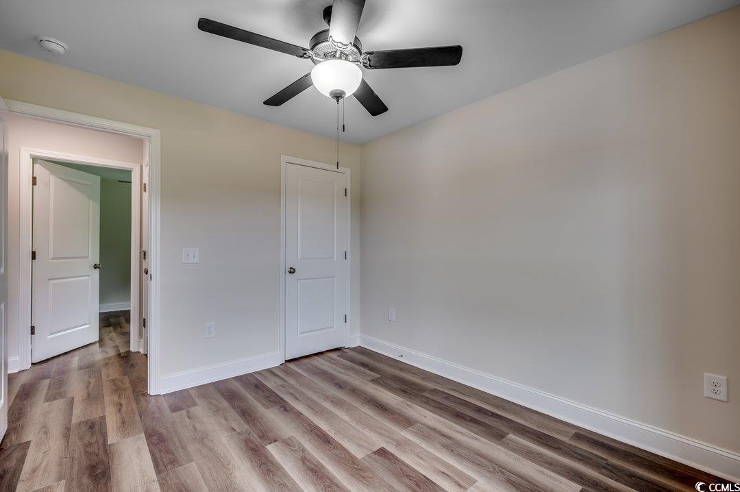 4911 Joyner Swamp Road Galivants Ferry, SC 29544 - Photo 21 of 28 Unfurnished bedroom with ceiling fan and hardwood / wood-style flooring