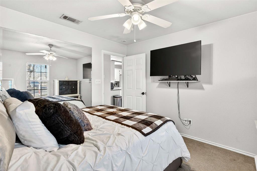 1001 South 4th Street Bonham, TX 75418 - Photo 15 of 27 a bedroom with a bed and a flat screen tv