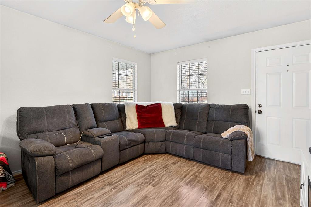 1001 South 4th Street Bonham, TX 75418 - Photo 6 of 27 a living room with furniture a ceiling fan and a window