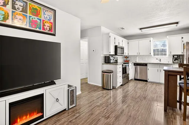 a kitchen with stainless steel appliances a stove top oven a sink and a refrigerator