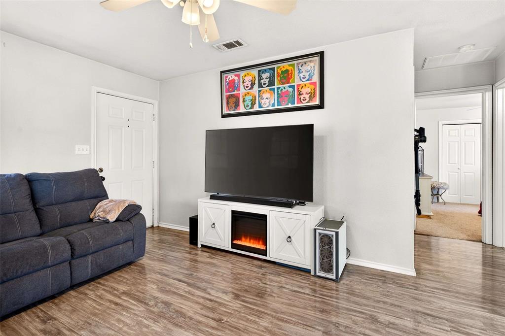 1001 South 4th Street Bonham, TX 75418 - Photo 9 of 27 a living room with furniture and a flat screen tv