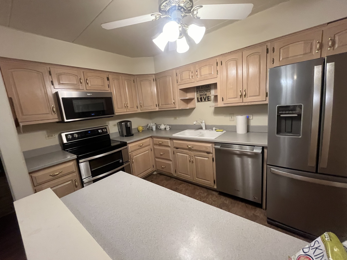 2807 Willow Road, Unit 105 Homewood, IL 60430 - Photo 7 of 8 a kitchen with a refrigerator a sink and white cabinets