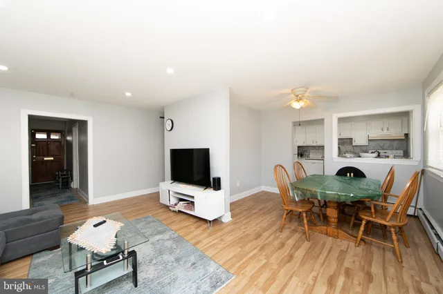 a dining room with furniture and wooden floor