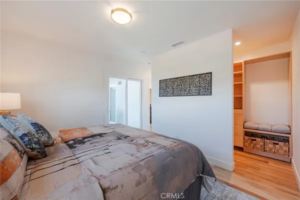 a bedroom with a bed and wooden floor