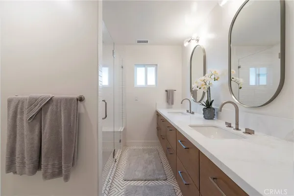 a spacious bathroom with a double vanity sink and a mirror