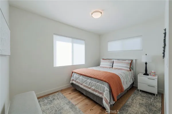 a bedroom with a bed lamp and a window