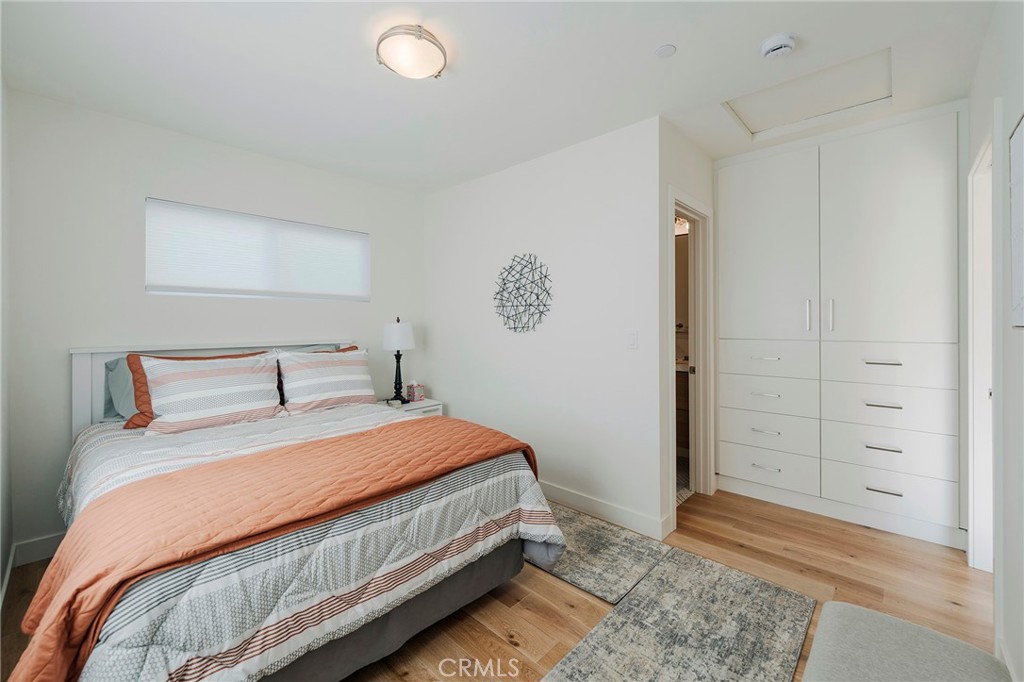 33792 Chula Vista Avenue Dana Point, CA 92629 - Photo 21 of 37 a bedroom with a bed and painting on the wall