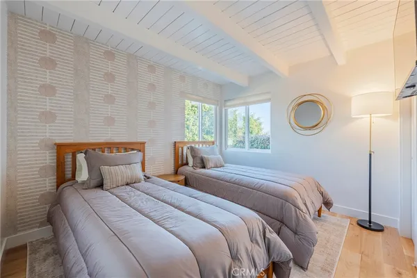 a bedroom with a bed and a lamp next to a window