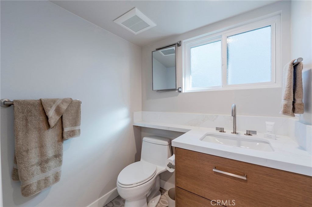 33792 Chula Vista Avenue Dana Point, CA 92629 - Photo 26 of 37 a bathroom with a sink toilet and mirror