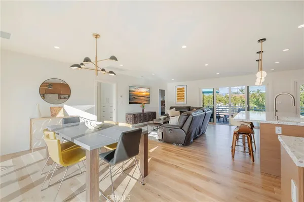 a view of a dining room with furniture wooden floor and chandelier