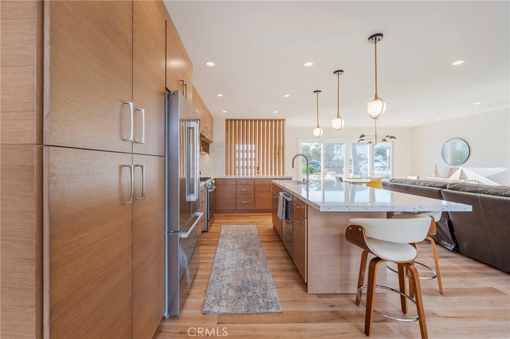 33792 Chula Vista Avenue Dana Point, CA 92629 - Photo 7 of 37 a kitchen with refrigerator and chairs