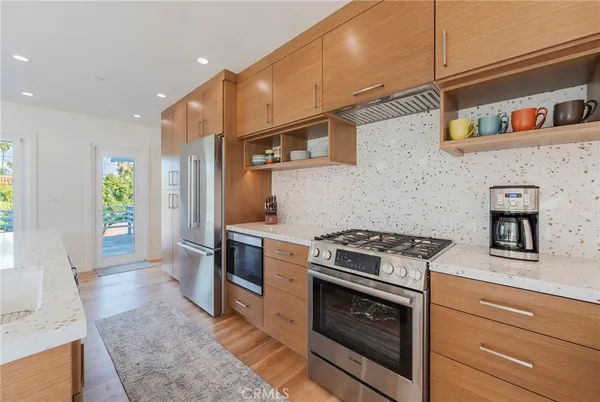 a kitchen with stainless steel appliances granite countertop a stove and a refrigerator