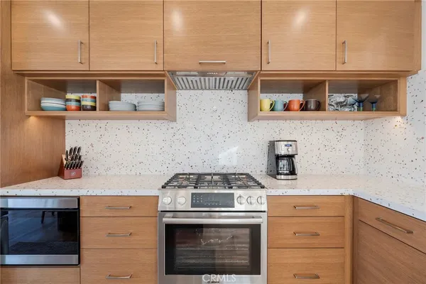 a kitchen with stainless steel appliances granite countertop a stove and a sink