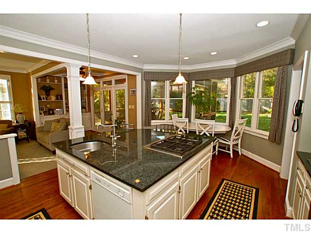 3217 Anderson Drive Raleigh, NC 27609 - Photo 6 of 25 a kitchen with a sink and wooden cabinets