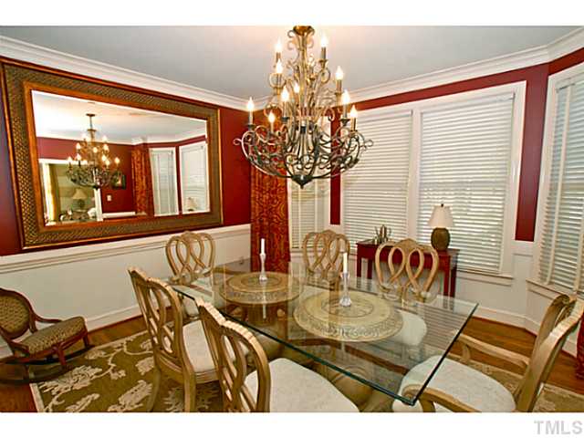 3217 Anderson Drive Raleigh, NC 27609 - Photo 10 of 25 a view of a dining room with furniture a chandelier and large windows