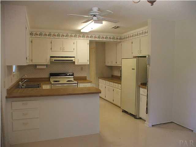6317 Rice Street Milton, FL 32583 - Photo 6 of 14 Kitchen View 2 shows tons of cabinet and counter space!