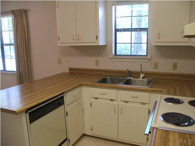 6317 Rice Street Milton, FL 32583 - Photo 7 of 14 The fully equipped kitchen overlooks the backyard.