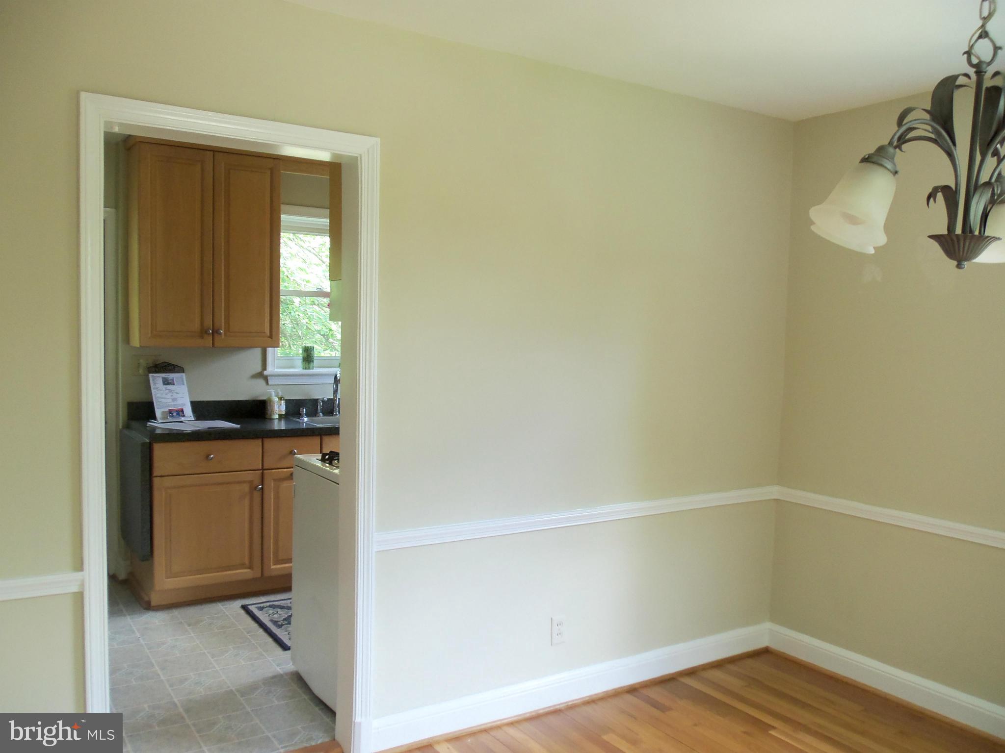 405 Penwood Road Silver Spring, MD 20901 - Photo 14 of 25 a kitchen with a refrigerator and a sink