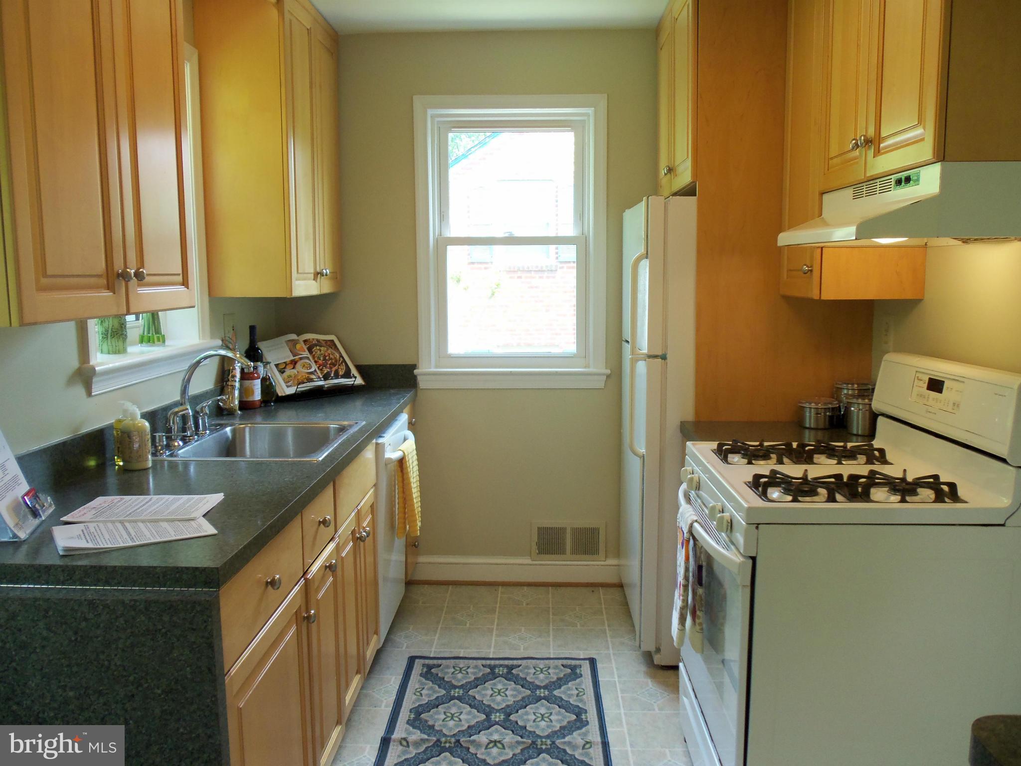 405 Penwood Road Silver Spring, MD 20901 - Photo 4 of 25 a kitchen with a sink stove top oven and cabinets