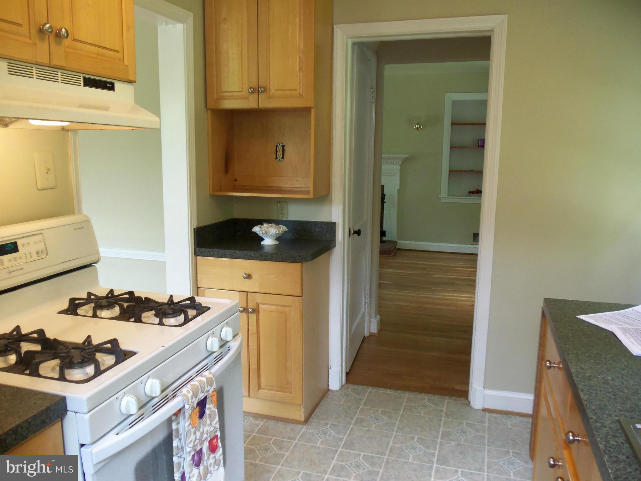 405 Penwood Road Silver Spring, MD 20901 - Photo 5 of 25 a kitchen with a stove and a refrigerator