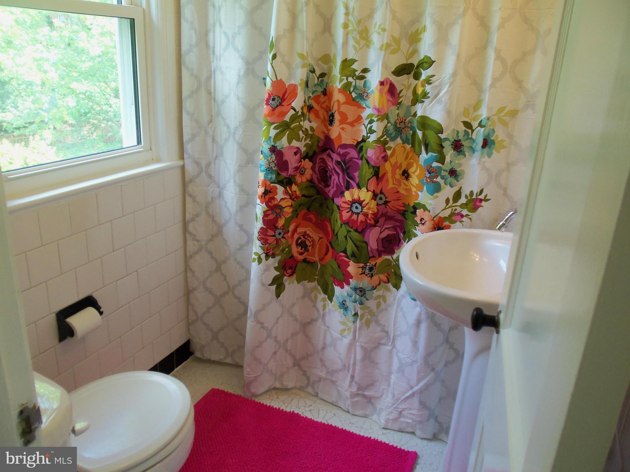 405 Penwood Road Silver Spring, MD 20901 - Photo 6 of 25 a bathroom with a toilet and a sink