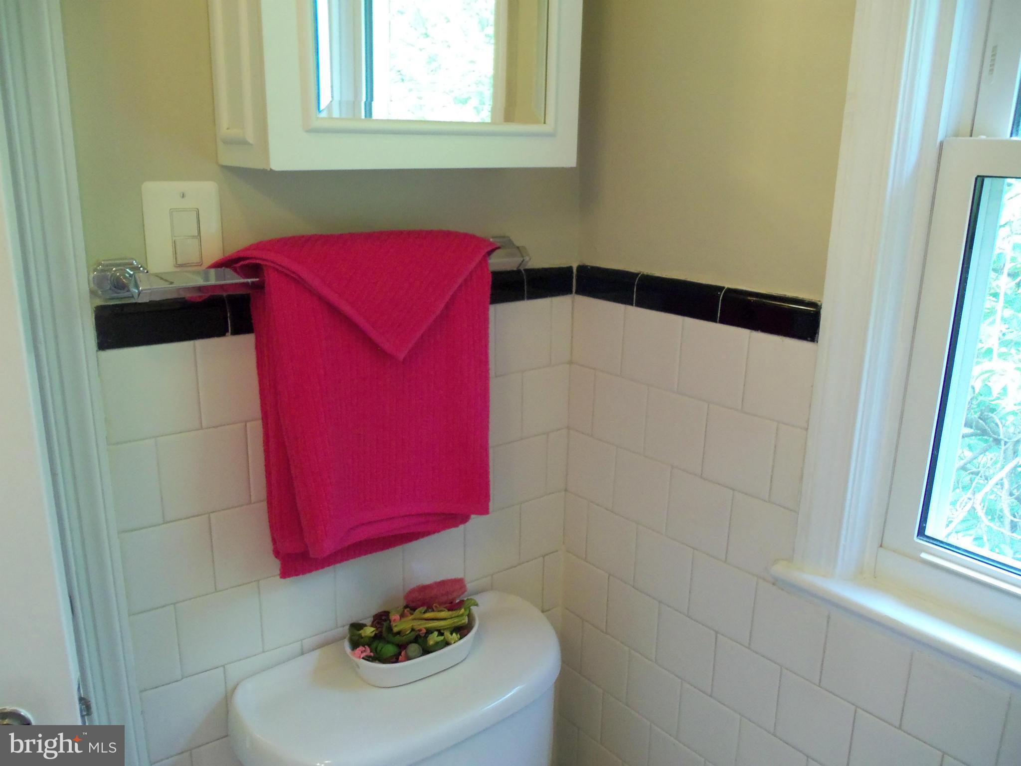 405 Penwood Road Silver Spring, MD 20901 - Photo 7 of 25 a bathroom with a sink and a mirror