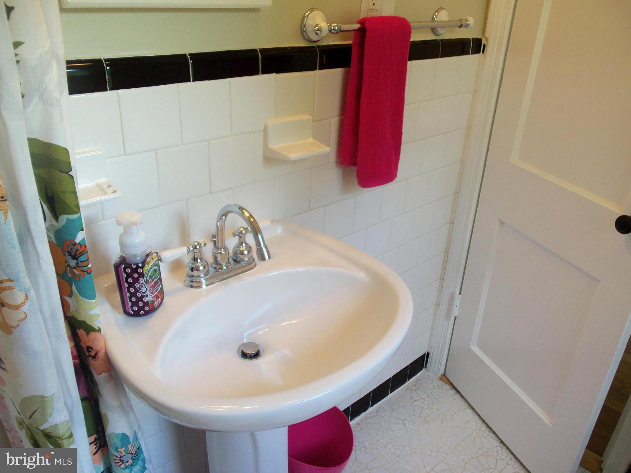 405 Penwood Road Silver Spring, MD 20901 - Photo 8 of 25 a bathroom with a sink and a mirror