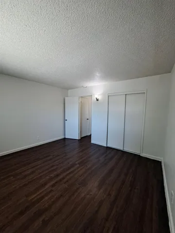 a view of an empty room and wooden floor