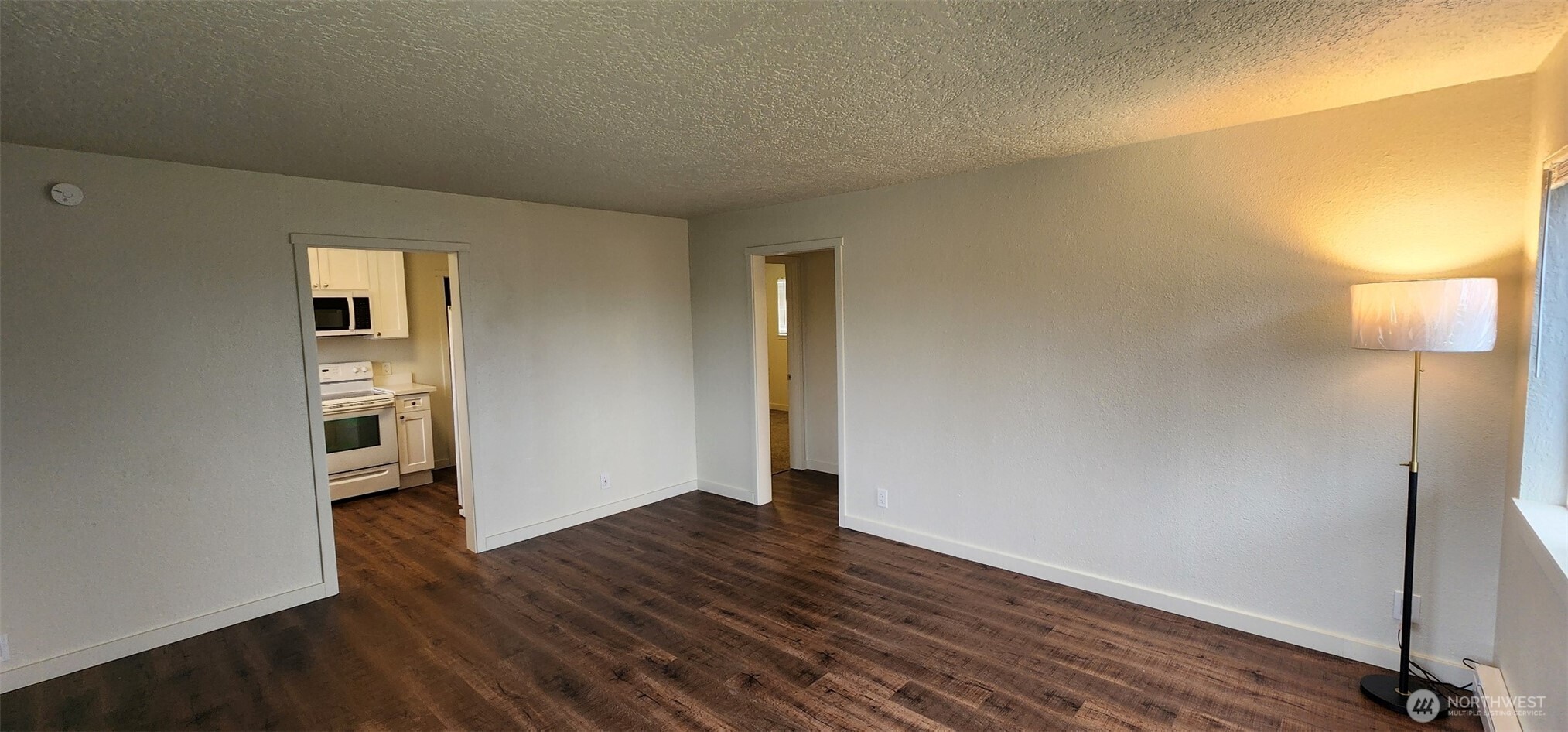 2350 East Pioneer Road Port Angeles, WA 98362 - Photo 12 of 40 an empty room with wooden floor and windows
