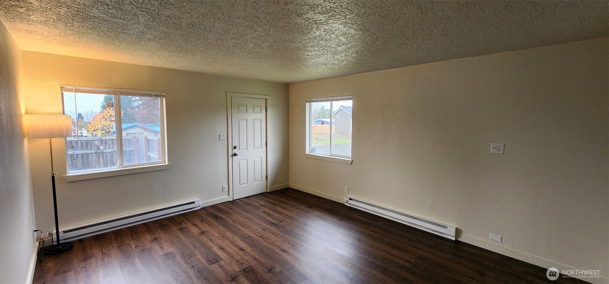 2350 East Pioneer Road Port Angeles, WA 98362 - Photo 13 of 40 an empty room with wooden floor and windows