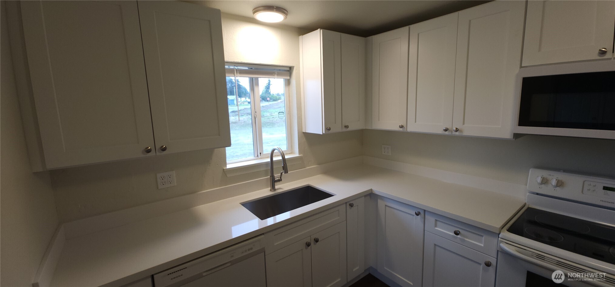 2350 East Pioneer Road Port Angeles, WA 98362 - Photo 15 of 40 a kitchen with a sink and cabinets