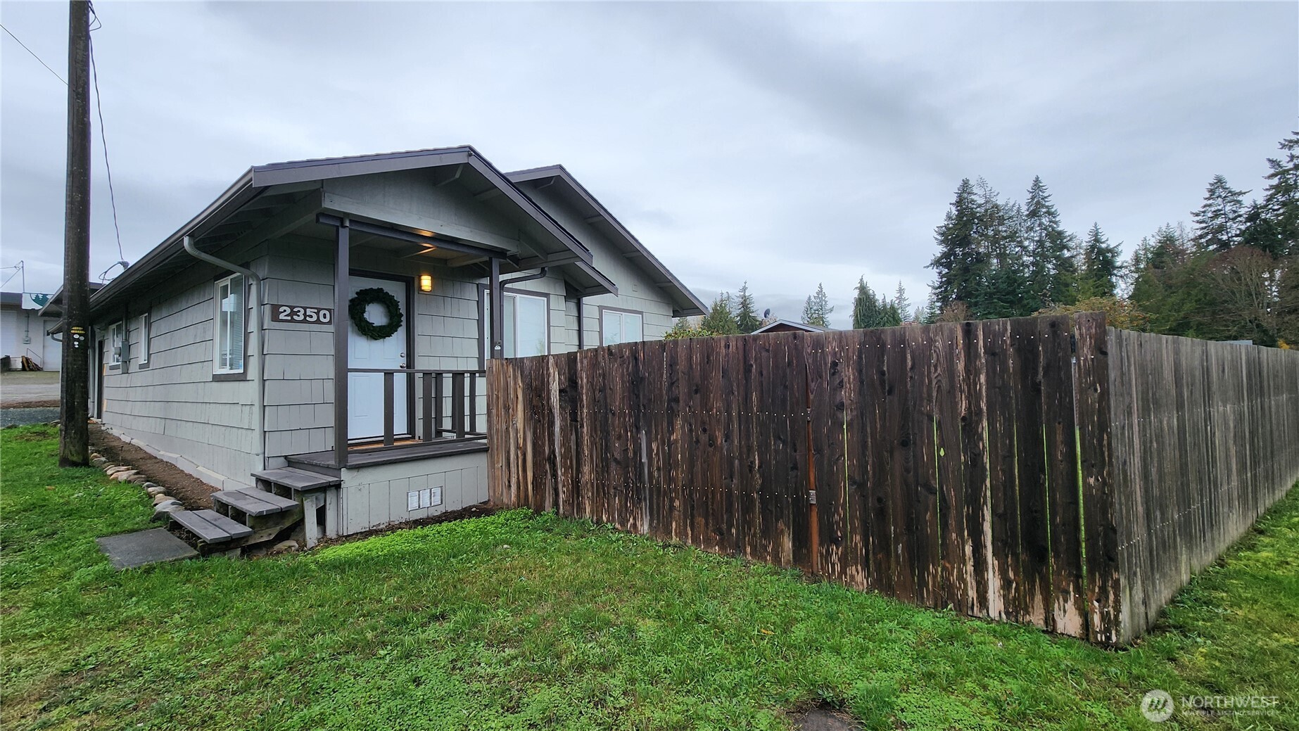 2350 East Pioneer Road Port Angeles, WA 98362 - Photo 3 of 40 a view of a house with wooden fence