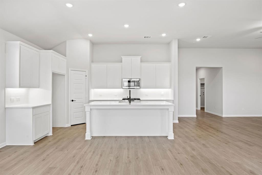 1507 Red Clover Avenue Van Alstyne, TX 75495 - Photo 14 of 30 a view of kitchen with wooden floor and electronic appliances