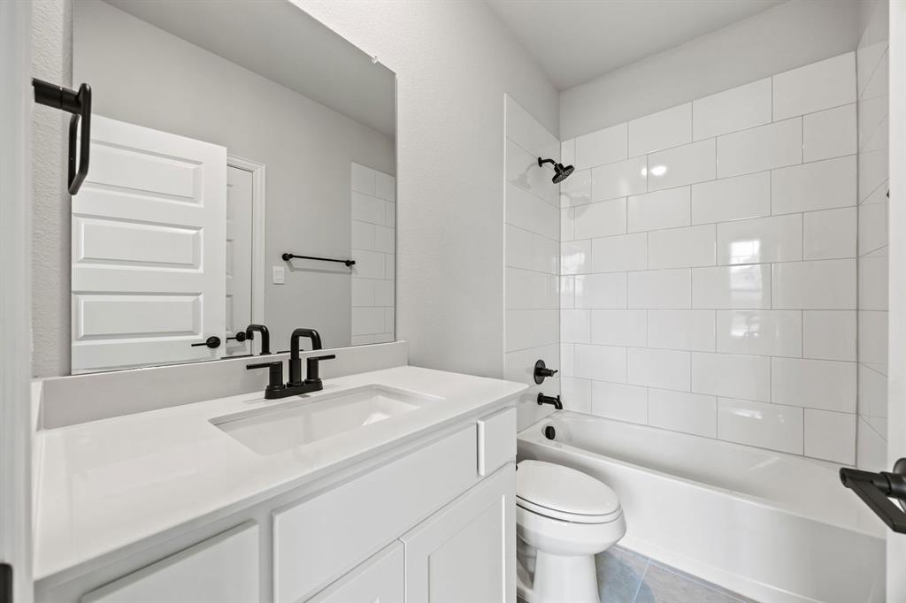 1507 Red Clover Avenue Van Alstyne, TX 75495 - Photo 16 of 30 a bathroom with a sink a toilet and shower