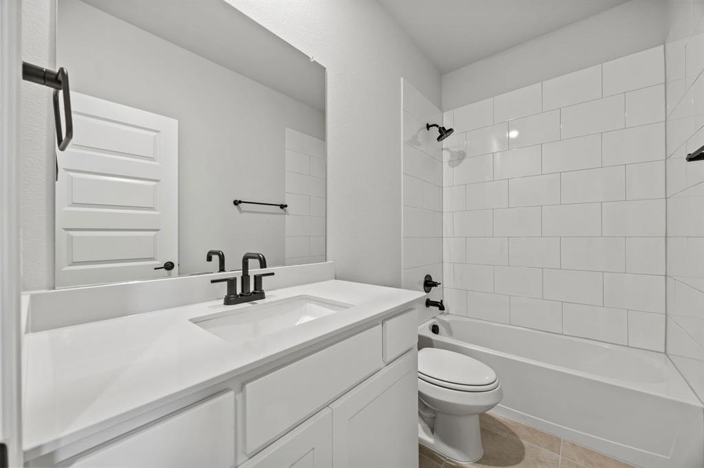 1507 Red Clover Avenue Van Alstyne, TX 75495 - Photo 20 of 30 a bathroom with a sink a toilet and shower