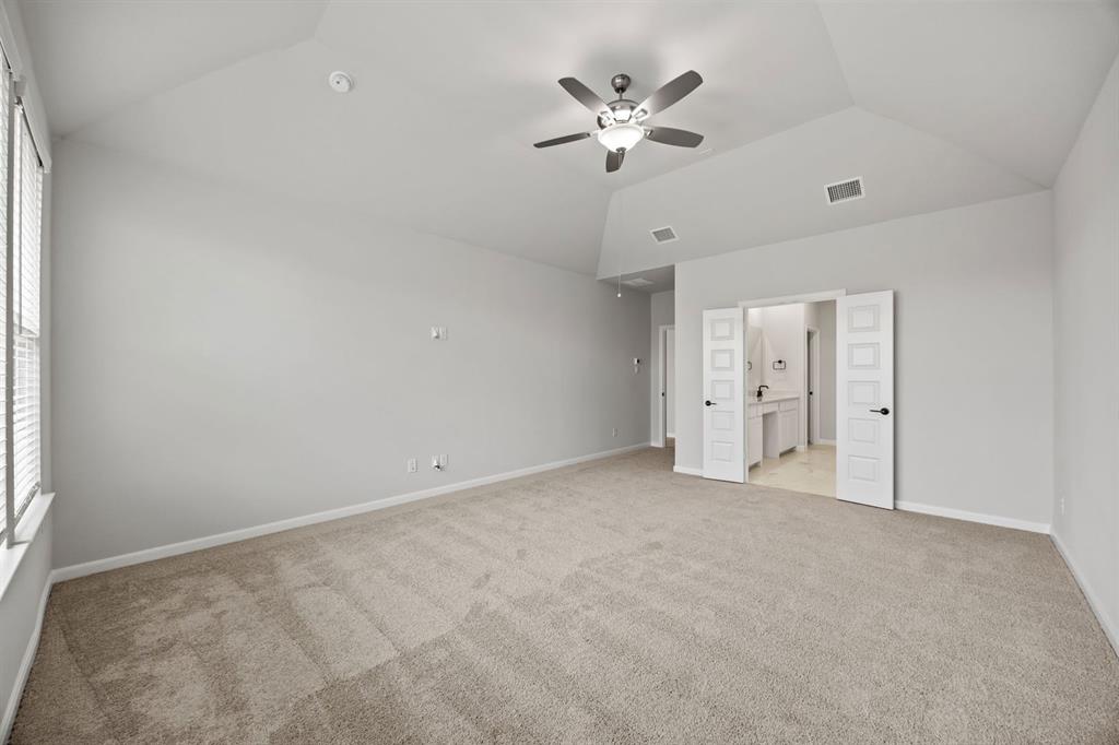 1507 Red Clover Avenue Van Alstyne, TX 75495 - Photo 24 of 30 an empty room with a chandelier fan and windows