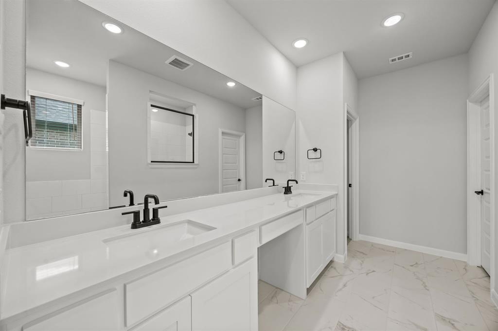 1507 Red Clover Avenue Van Alstyne, TX 75495 - Photo 27 of 30 a spacious bathroom with a double vanity sink mirror and