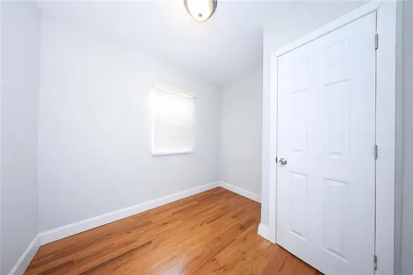 a view of a room with wooden floor and fan