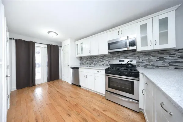 a kitchen with stainless steel appliances granite countertop a stove and a refrigerator