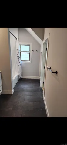 a view of an entryway with wooden floor