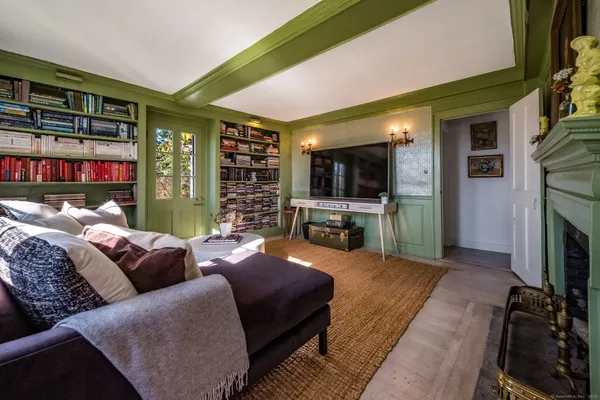 a bedroom with furniture and a fireplace