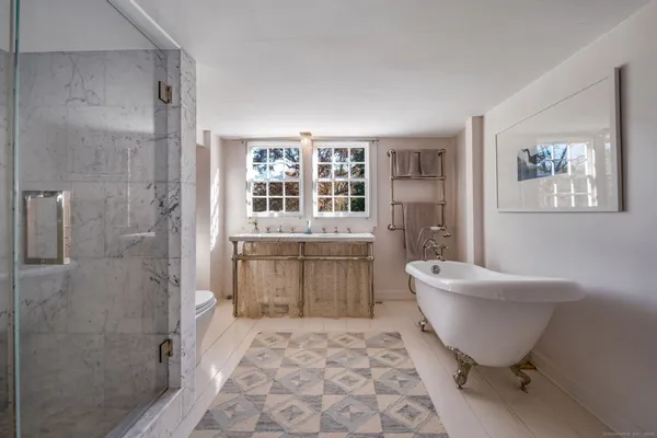 a spacious bathroom with a bathtub and toilet