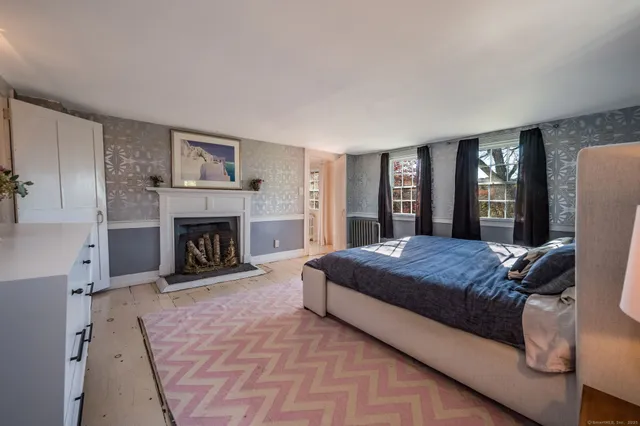 a spacious bedroom with a large bed and a fireplace