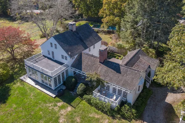 an aerial view of a house with a big yard