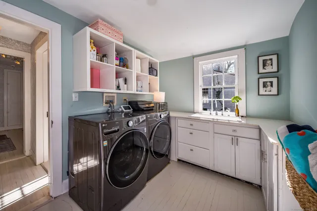 a utility room with cabinets dryer and washer
