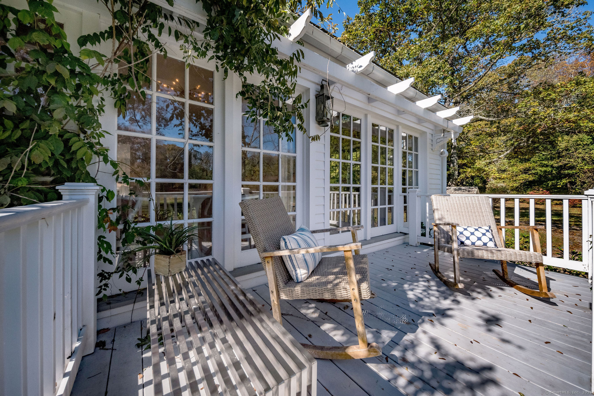 4 Hamburg Road East Haddam, CT 06423 - Photo 31 of 40 a view of a patio with two couches and potted plants with wooden floor and fence