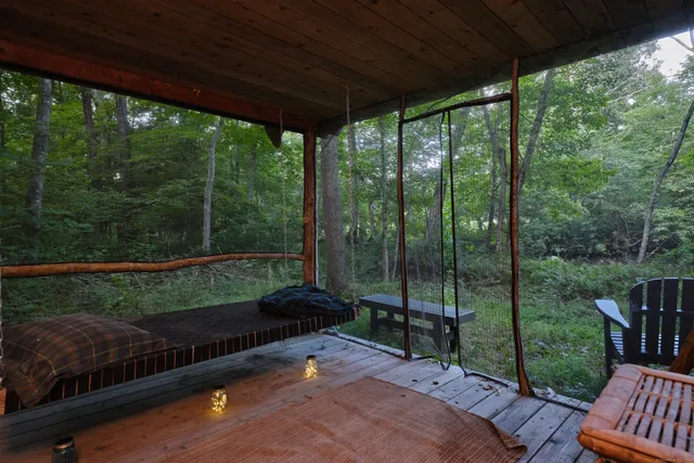 a view of a porch with furniture and garden
