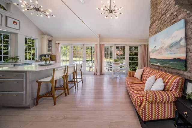 a living room with furniture and large windows