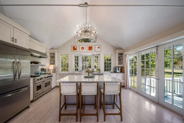 a view of a dining room with furniture large window and wooden floor