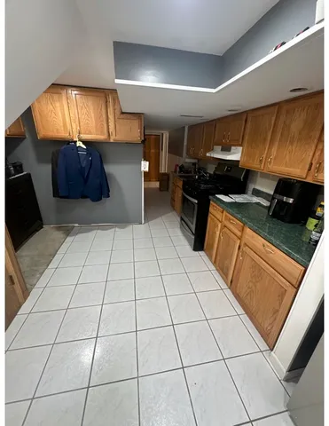 a kitchen with stainless steel appliances a counter space and cabinets